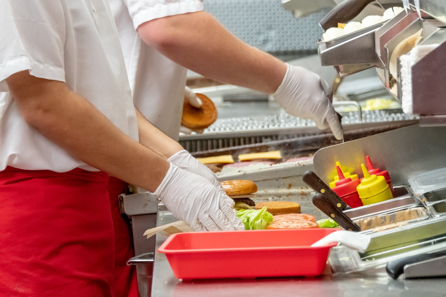 Fast food workers working in a hamburger restaurant